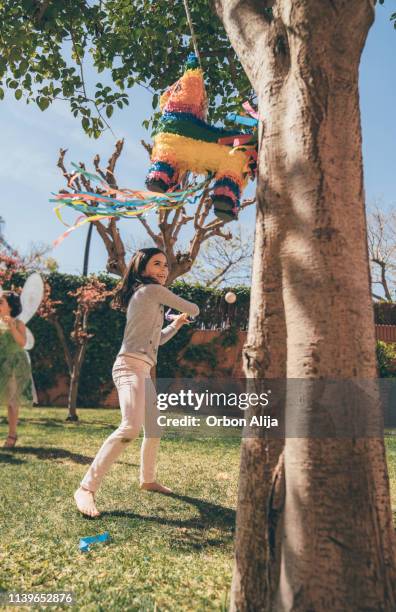 boys breaking piñata at a party - tiny mexican girl stock pictures, royalty-free photos & images