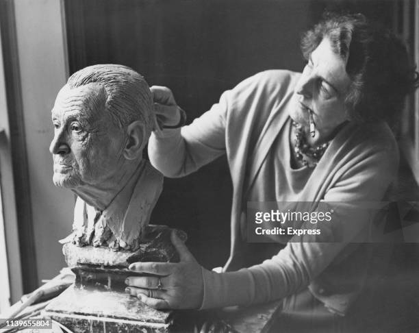 Sculptor Jane Jackson puts the finishing touches to a wax head of writer W. Somerset Maugham, ready to be displayed at the Madame Tussauds waxwork...