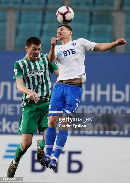 Grigori Morozov of FC Dinamo Moscow and Oleg Ivanov of FC Akhmat Grozny vie for the ball during the Russian Premier League match between FC Dinamo...