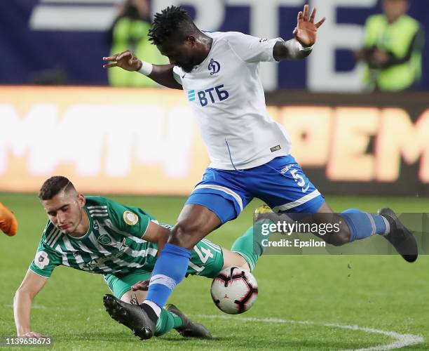 Abdul Aziz Tetteh of FC Dinamo Moscow and Ravanelli of FC Akhmat Grozny vie for the ball during the Russian Premier League match between FC Dinamo...