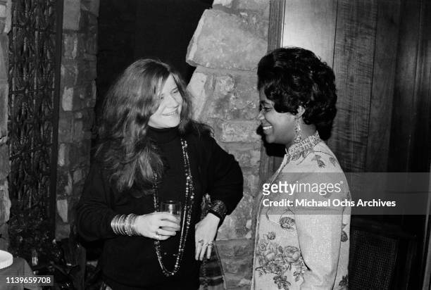 American blues and soul singer Janis Joplin talking to soul singer Carla Thomas at the Stax Records Christmas party in Memphis, Tennessee, 20th...