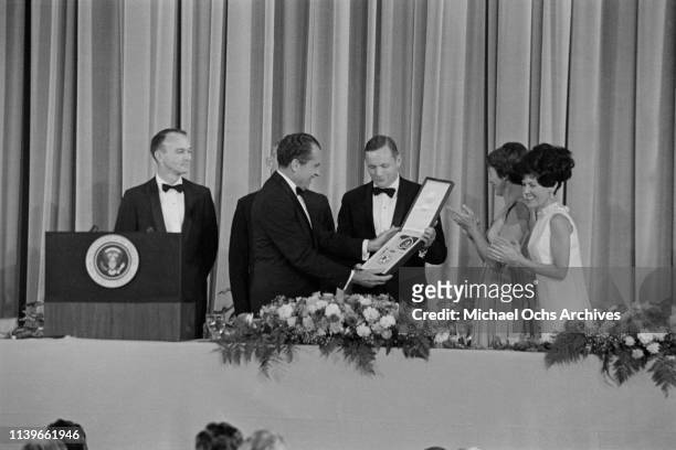 President Richard Nixon hosts a dinner at the Century Plaza Hotel in Los Angeles for the Apollo 11 astronauts, and presents them with the...