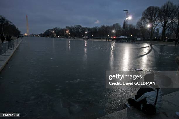 Eve of Inauguration Day for President-elect Barack Obama In Washington, United States On January 19, 2009-A man sits along the edge of the Reflecting...