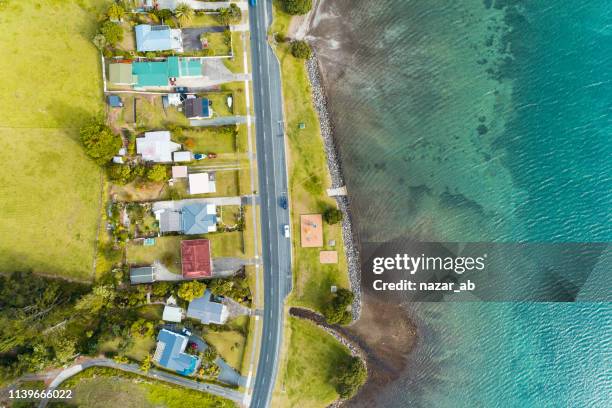 top looking down at houses along the beach. - new zealand beach house stock pictures, royalty-free photos & images