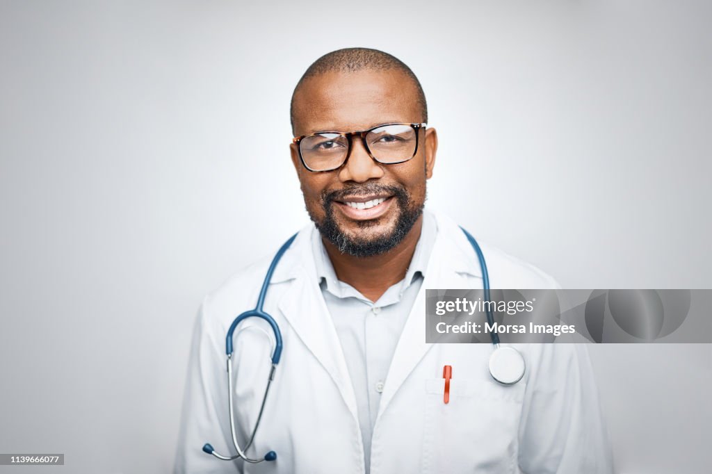 Doctor wearing eyeglasses on white background