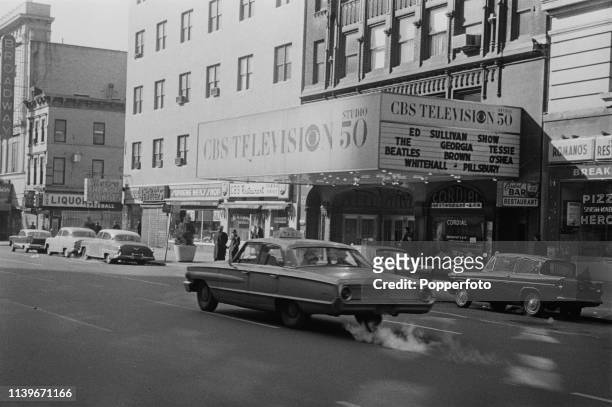 View of a car driving past CBS Television Studio 50 Theatre on Broadway prior to an upcoming performance by The Beatles on The Ed Sullivan Show at...