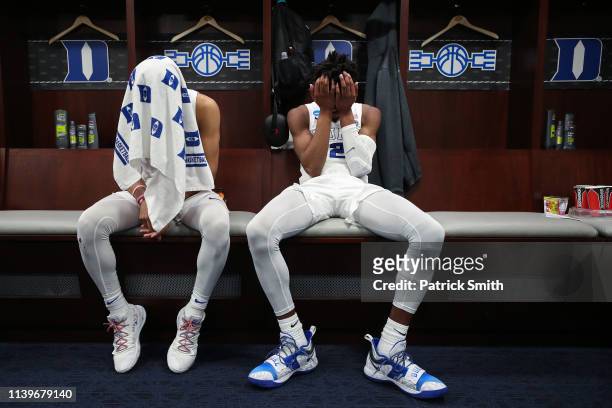 Tre Jones and Cam Reddish of the Duke Blue Devils react in the locker room after their teams 68-67 loss to the Michigan State Spartans in the East...