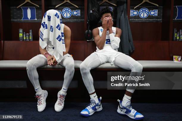 Tre Jones and Cam Reddish of the Duke Blue Devils react in the locker room after their teams 68-67 loss to the Michigan State Spartans in the East...