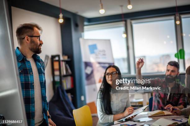 young people working in team - checked shirt stock pictures, royalty-free photos & images