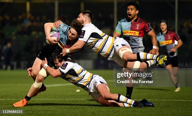Quins player Cadan Murley is tackled by Francois Venter and Cornell du Preez during the Challenge Cup Quarter Final match between Worcester Warriors...