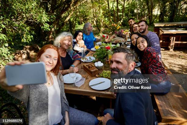 young woman taking a selfie on a garden party - photographing garden stock pictures, royalty-free photos & images