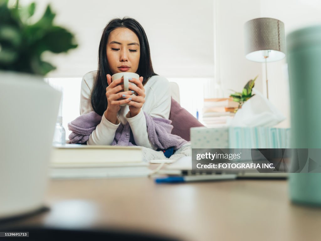 Young Asian woman sick at home