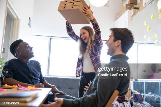 lunch break in the office with a fresh made pizza - lunch and learn stock pictures, royalty-free photos & images