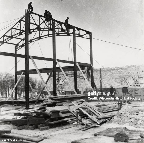 Men working on construction of dormitories on the University of Wisconsin-Madison campus, Madison, Wisconsin, 1925. Construction works are on top of...