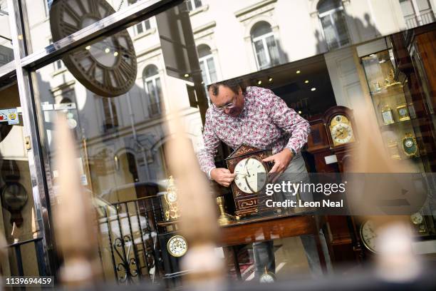 Duncan Clements of Pendulum of Mayfair antique clock specialists carries out the summertime adjustment of the clocks, regulators and timepieces in...