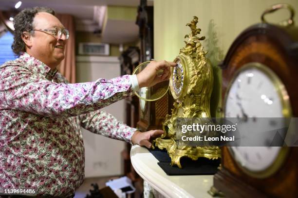 Duncan Clements of Pendulum of Mayfair antique clock specialists carries out the summertime adjustment of the clocks, regulators and timepieces in...