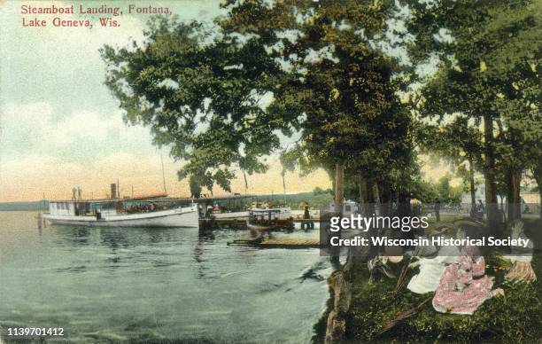 View from shoreline of a steamboat landing on Lake Geneva, Fontana, Wisconsin, 1905. A group of women are gathered on the shore.