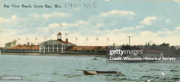 View across water towards Bay View Beach, with several boats in the foreground, and buildings behind them, Green Bay, Wisconsin, 1905.