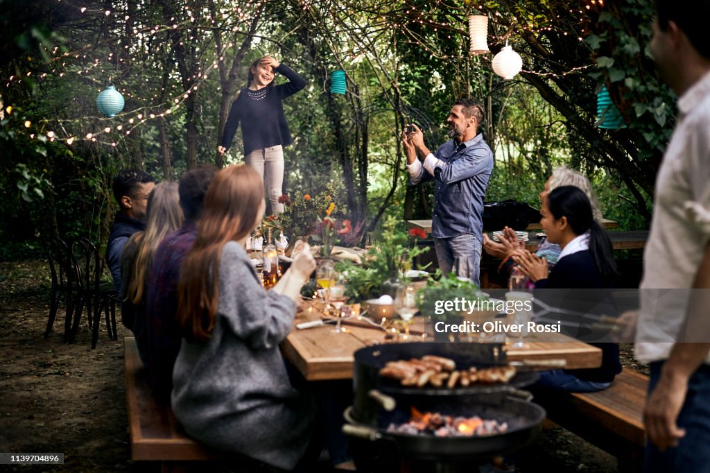 Girl making a speech on a garden party
