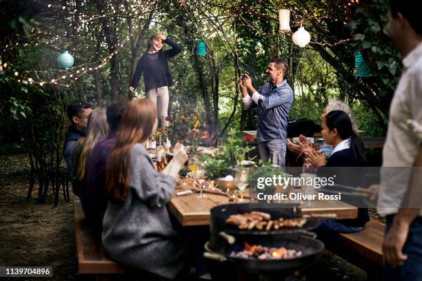 girl making a speech on a garden party - grill zubereitung stock-fotos und bilder