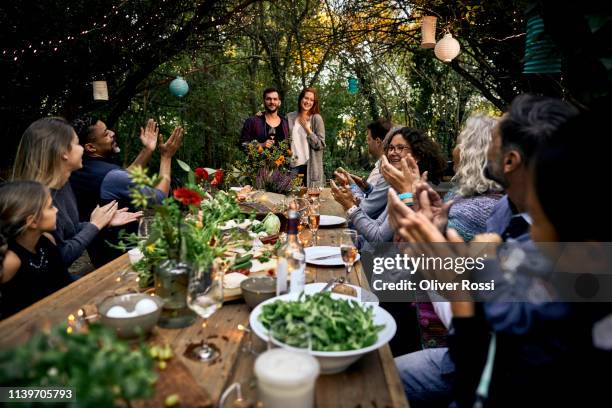 couple making a speech on a garden party - garden party stock-fotos und bilder