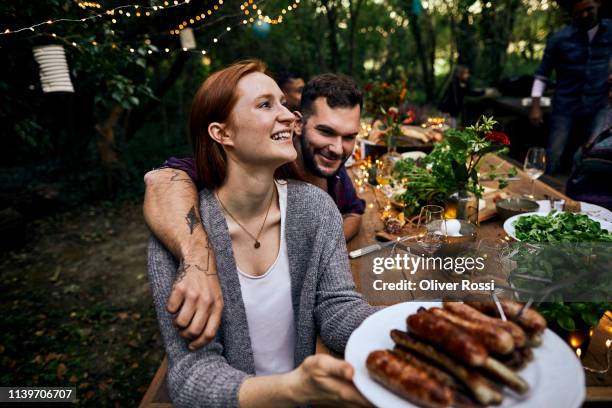 happy couple on a barbecue garden party - viande-grillée photos et images de collection