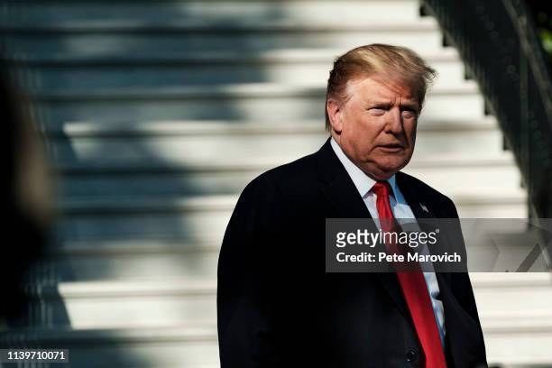 President Donald Trump stops to talk to the media about the shooting in a California synagogue as he makes his way to Marine One on the South Lawn of...