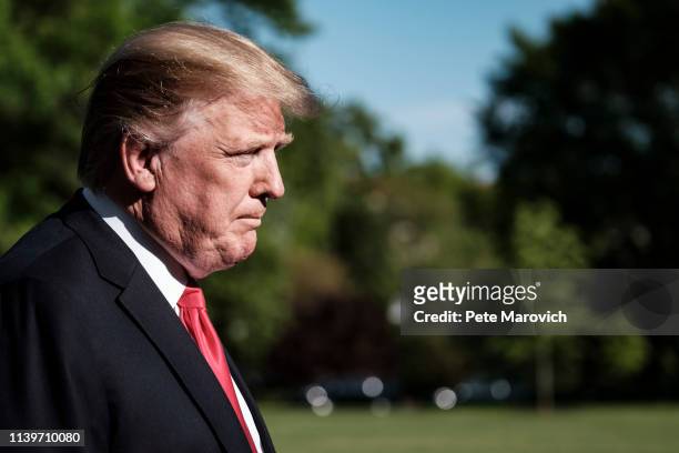 President Donald Trump stops to talk to the media about the shooting in a California synagogue as he makes his way to Marine One on the South Lawn of...