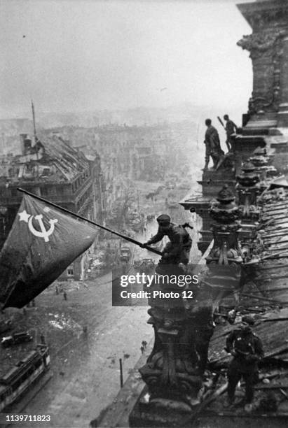 Russian flag is flown over the ruins of the Reichstag, in Berlin at the end of world war two. .