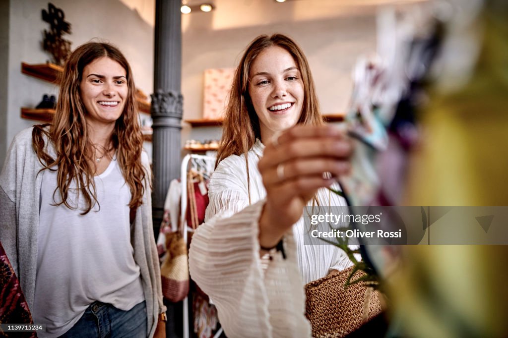 Two happy women shopping in a fashion store