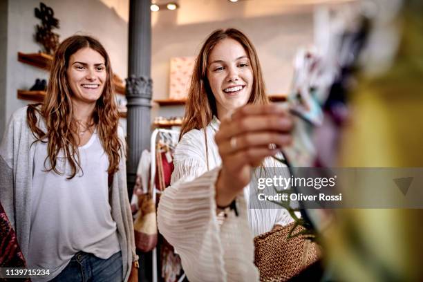 two happy women shopping in a fashion store - casual clothing store stock pictures, royalty-free photos & images