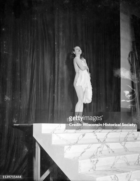 Fan dancer Rosita Carmen performing at the Orpheum Theatre, while offstage she is accompanied by the organist Mac Bridwell, Madison, Wisconsin,...