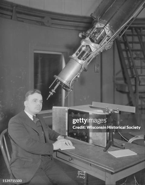 Man is sitting near a new photo electric cell equipment at Washburn Observatory on the University of Wisconsin-Madison campus, Madison, Wisconsin,...