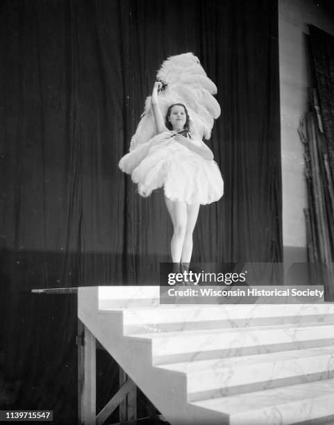 Rosita Carmen, burlesque dancer, performing with feather fans on the stage of the Orpheum Theatre, Madison, Wisconsin, September 28, 1933.