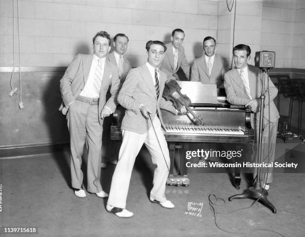Anthony 'Tony' Salerno's Gypsy Melodians posing at WIBA studios, Madison, Wisconsin, August 23, 1932. Tony is leaning against the piano with his...