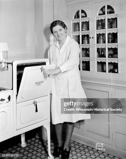 Green County 4-H Club girl, Helen Haldeman of Monroe, posing in the Madison Gas and Electric Co demonstration kitchen, while she competes in the...