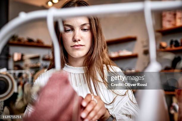 portrait of young woman in a fashion store - ropa fotografías e imágenes de stock