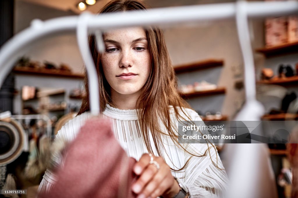 Portrait of young woman in a fashion store