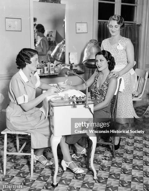 Actress Raquel Torres gets a facial from Ida Osthoff, manager of Grace Beauty Shop 132 State Street, while Josephine Armbrecht, beauty operator,...