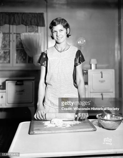 Dane county 4-H Club girl, Agatha Dermosky, of Sun Prairie, rolls pie dough in the Madison Gas and Electric Co demonstration kitchen during...