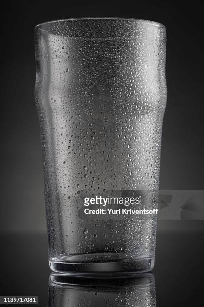 empty beer glass with condensation - condensation glass stock-fotos und bilder