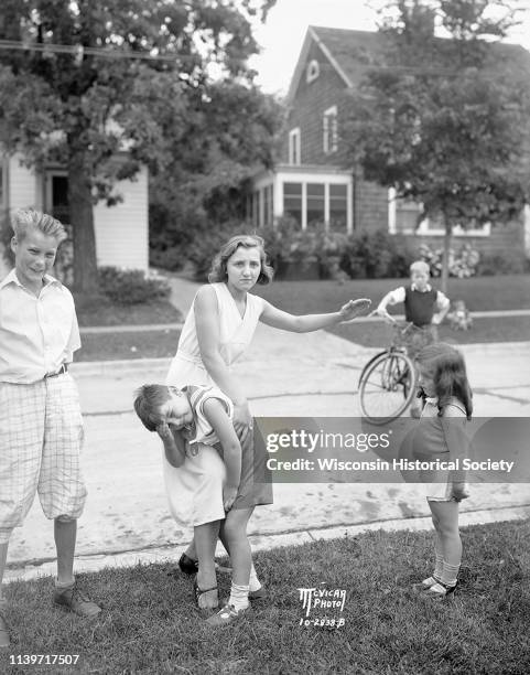 Virginia Gillette demonstrates how residents in the 400 block of Virginia Terrace are combating traffic dangers by spanking, Madison, Wisconsin,...