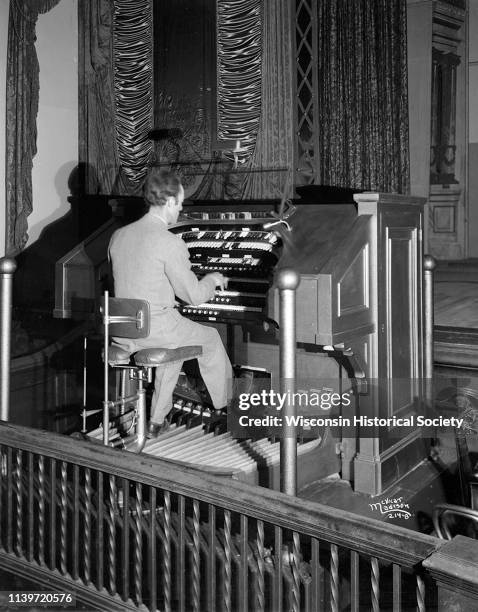 Man playing Kimball organ at the Orpheum Theatre, Madison, Wisconsin, April 5, 1927.