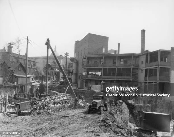 The Orpheum Theatre under construction, 216 State Street, looking east at back side of buildings on State Street, with construction workers, truck...