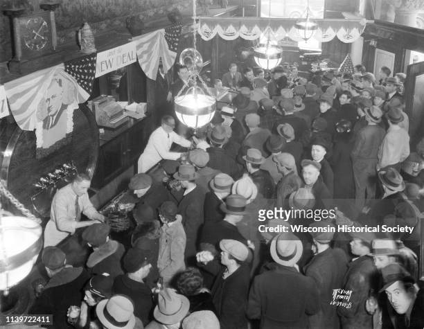 Overhead view of bar and crowd in Fauerbach Brewing Co tavern at 651 Williamson Street, celebrating the end of Prohibition, Madison, Wisconsin, April...