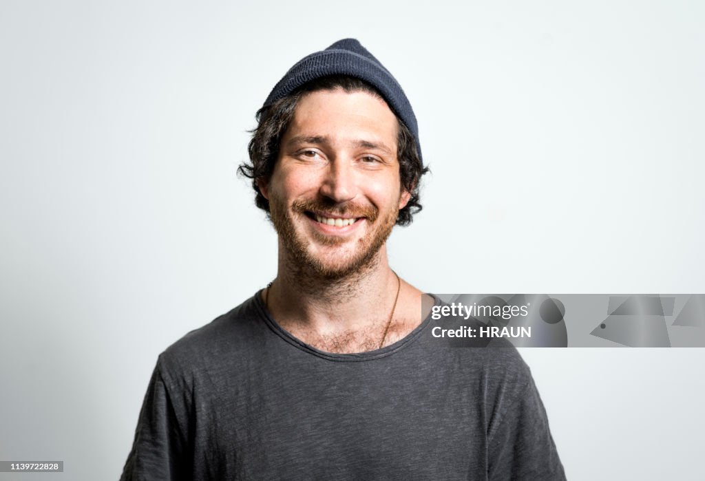 Portrait of man smiling on gray background