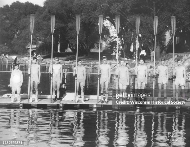 University of Wisconsin-Madison crew team holding their long oars, with coxswain on a pier on Lake Mendota, Madison, Wisconsin, May 26, 1931.