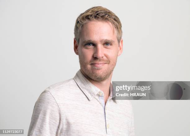 portrait of smiling young man - blonde hair man stock pictures, royalty-free photos & images