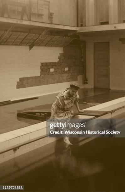Esther Eloise McGilvra, member of the Menomonie High School class of 1905, depicted as a swimmer, next to a wooden diving board, Menomonie,...