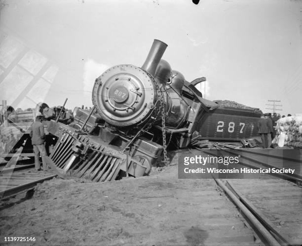 Derailed locomotive and coal car, Black River Falls, Wisconsin, 1900. Wreck on the Chicago, St. Paul, Minneapolis, and Omaha Railway, locomotive, in...